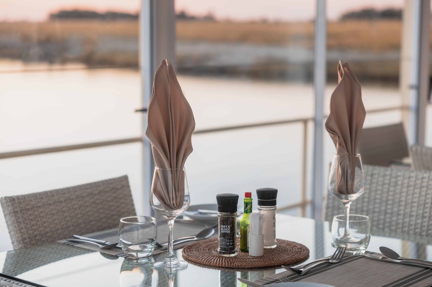 Dining table set on the deck overlooking the river at Chobe Princess