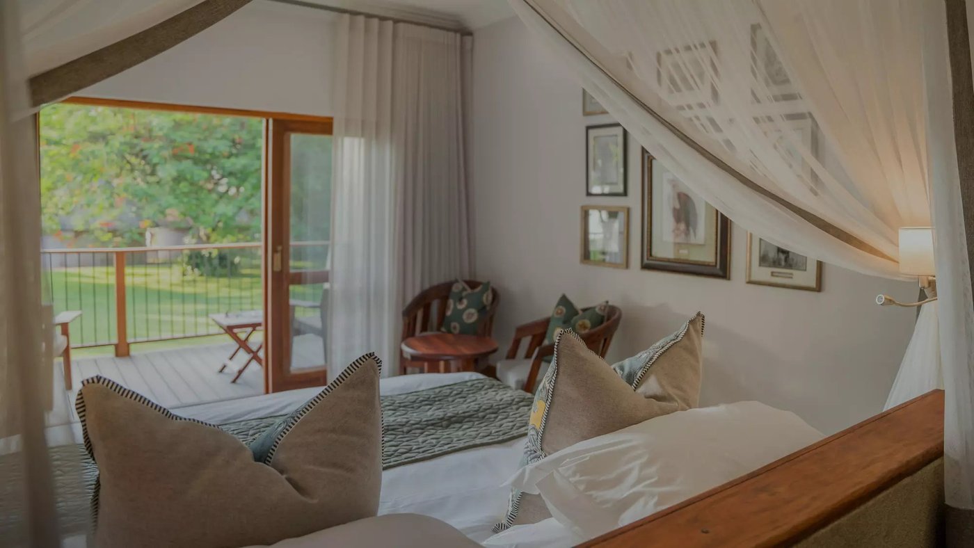 Canopy bed suite with a private deck at Chobe Safari Lodge