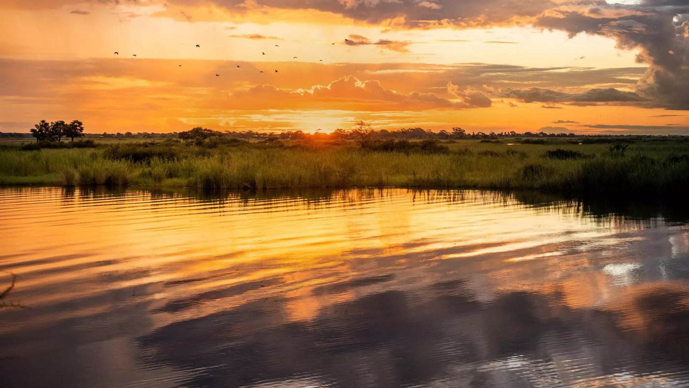 Sunset reflected across the water near Chobe Safari Lodge