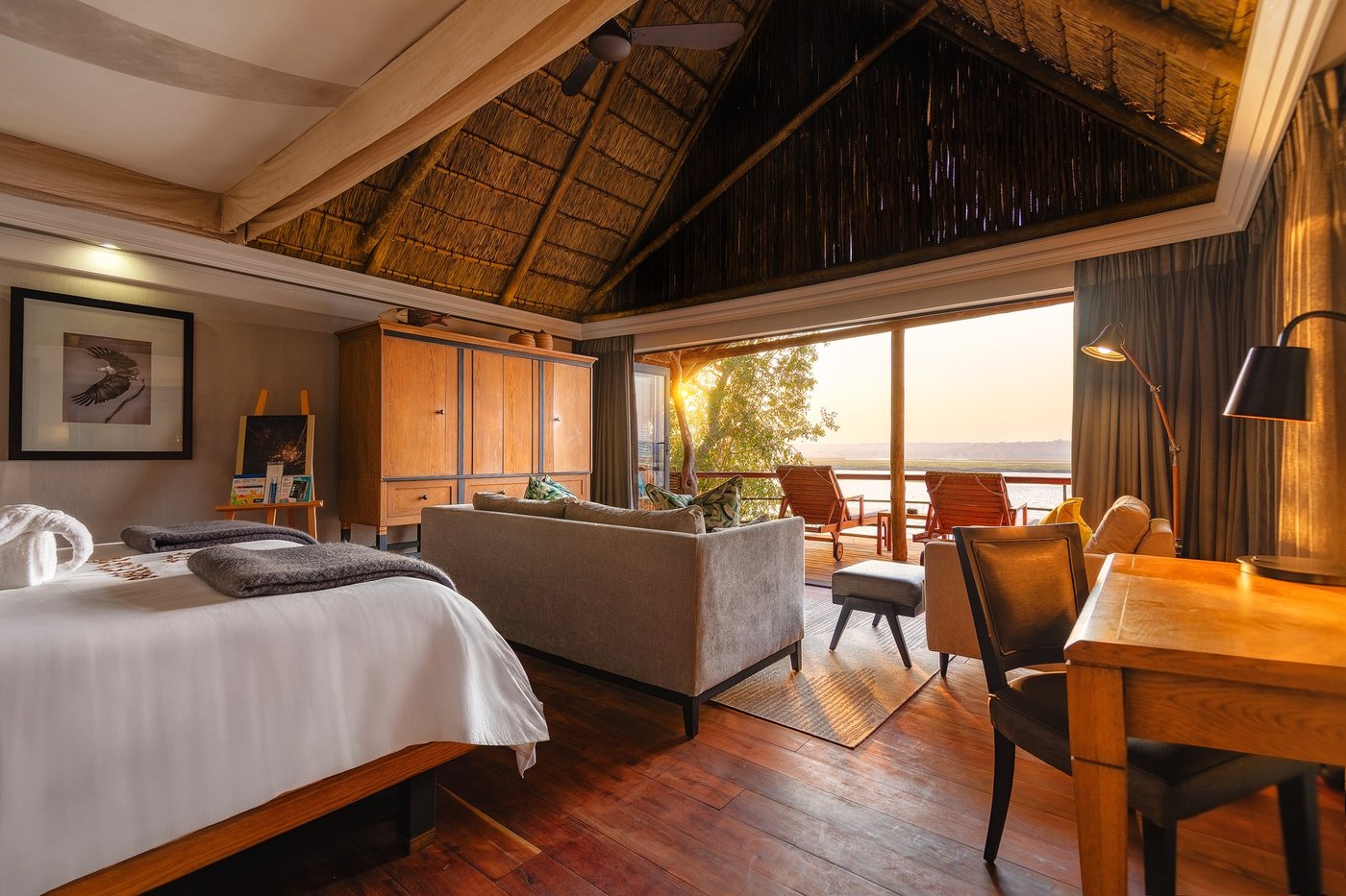 Bedroom and lounge area opening onto river views at Chobe Water Villas