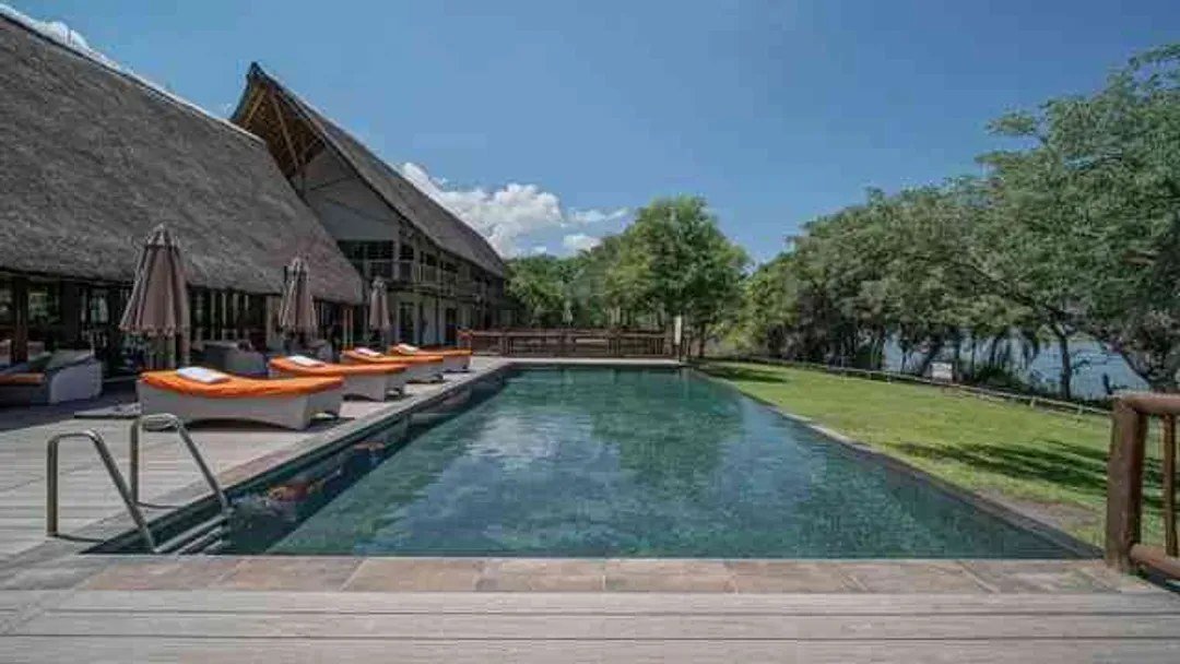 Swimming pool beside the thatched main building at Cresta Mowana Safari Resort & Spa