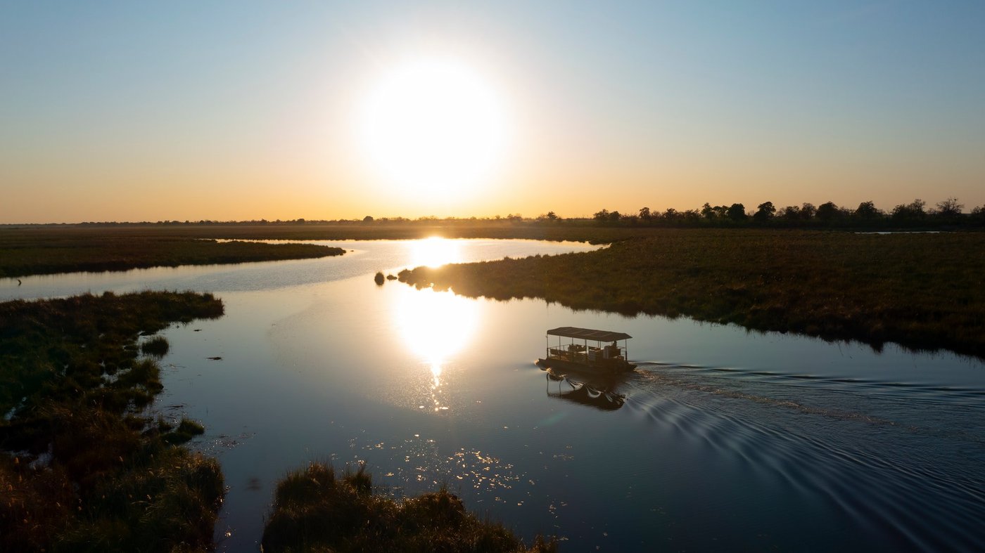 Sun reflected on the river at sunset near DumaTau Camp