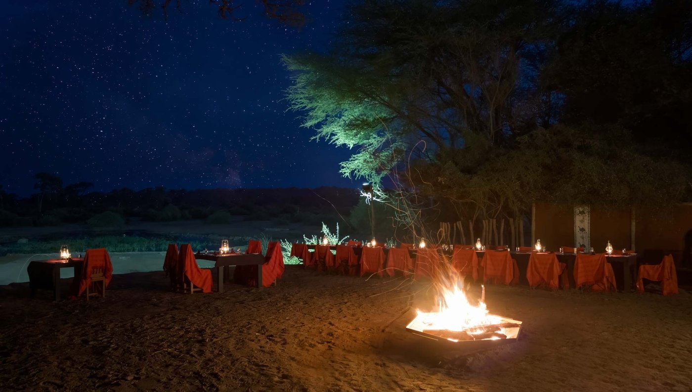Boma dinner setup around a campfire under the stars at Elephant Valley Lodge