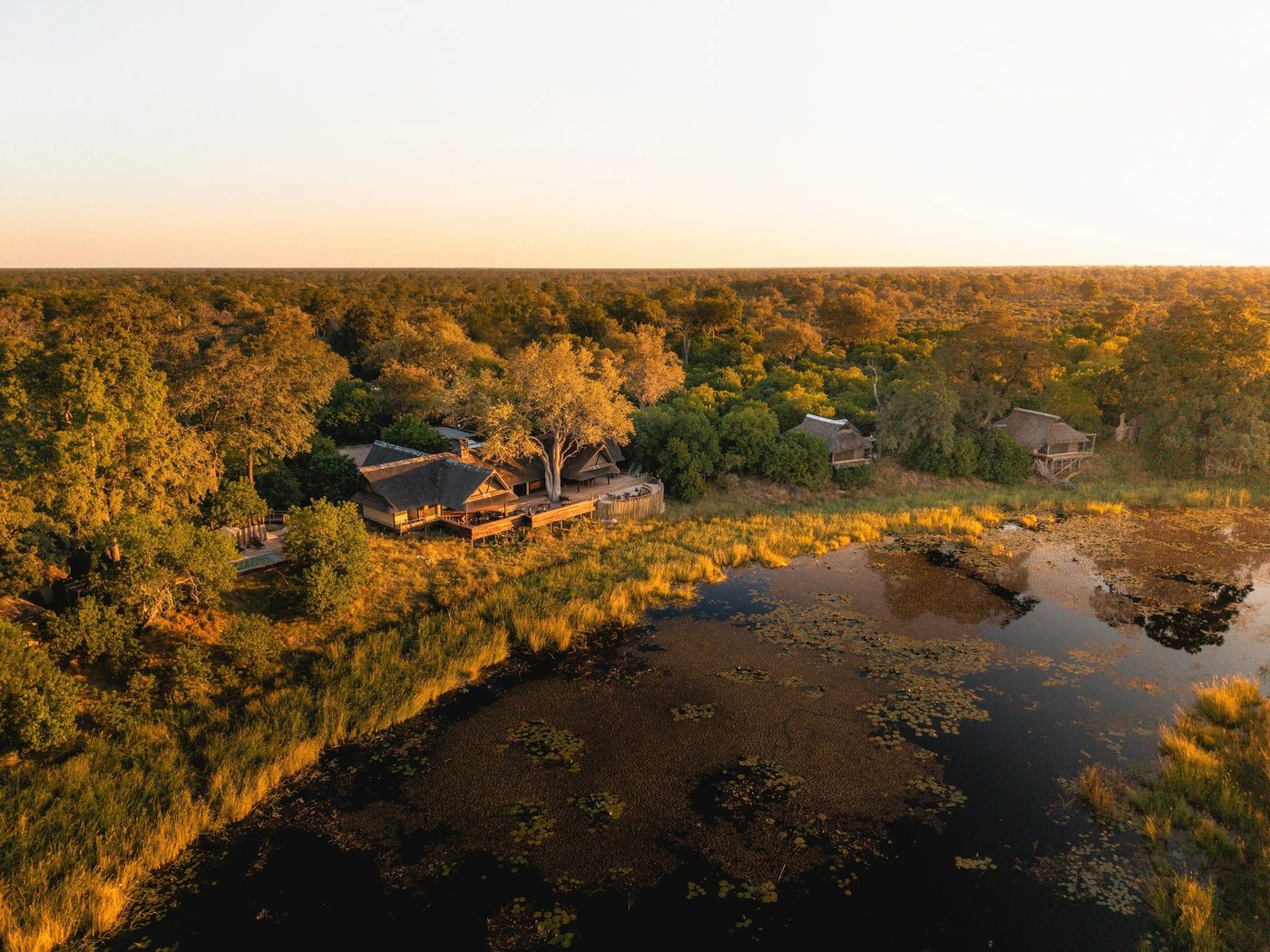 Aerial view of the tented camp on the floodplain at dusk at King's Pool Camp, Chobe