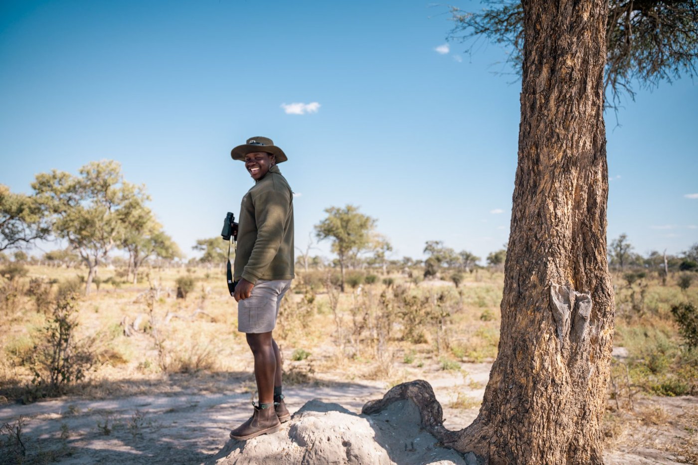 Guide scanning the bush from a termite mound at Lebala Camp