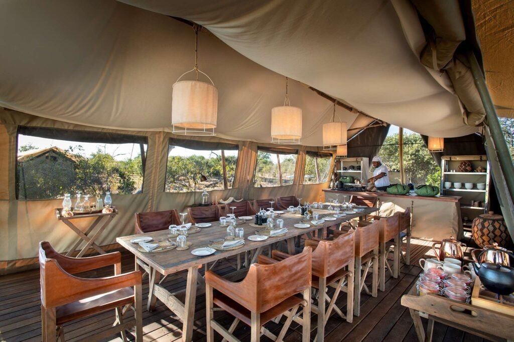 Dining table set inside the mesh-walled tent at Linyanti Expeditions