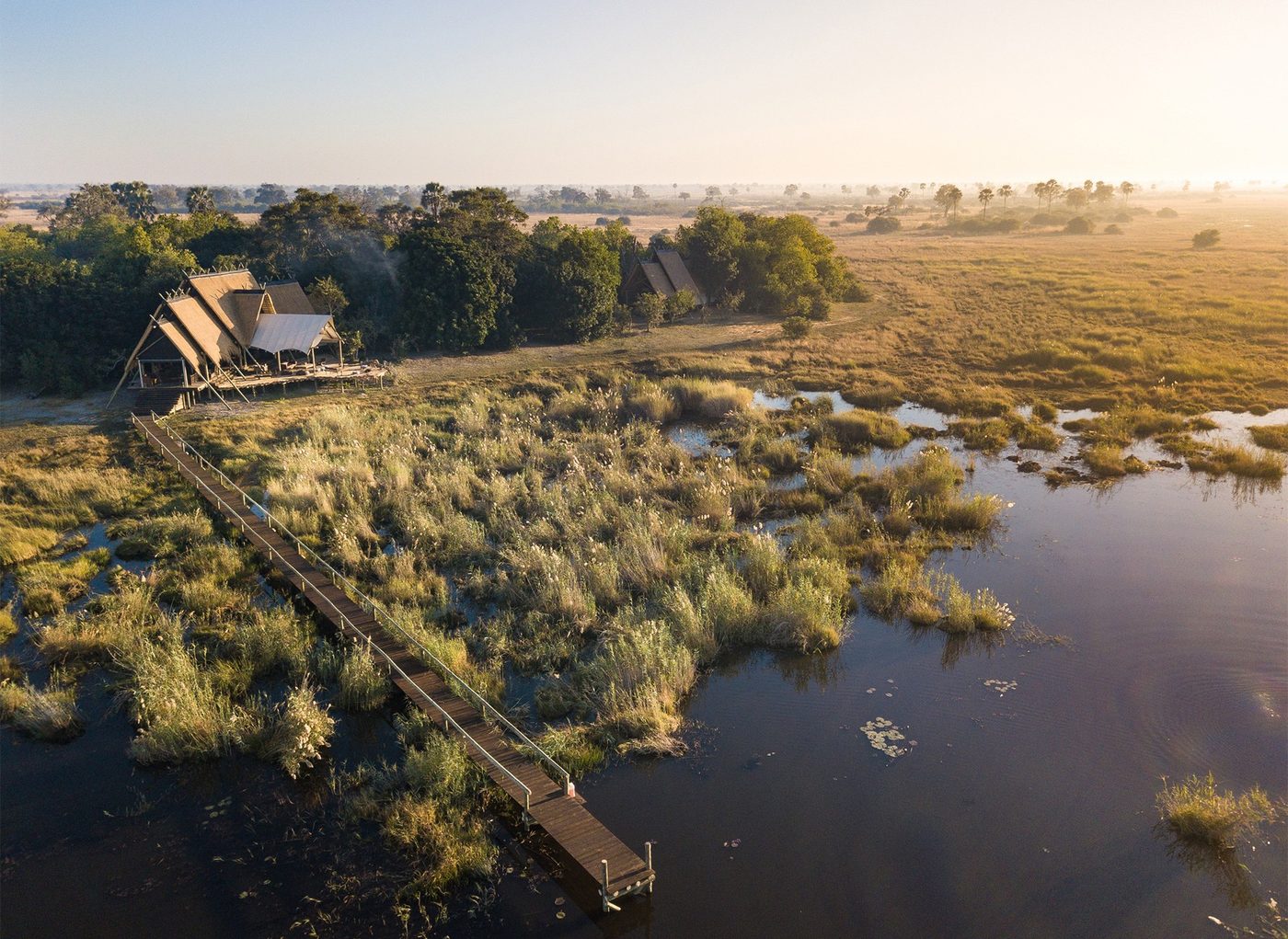 Aerial view of the camp on the river at dawn at Selinda Camp, Chobe