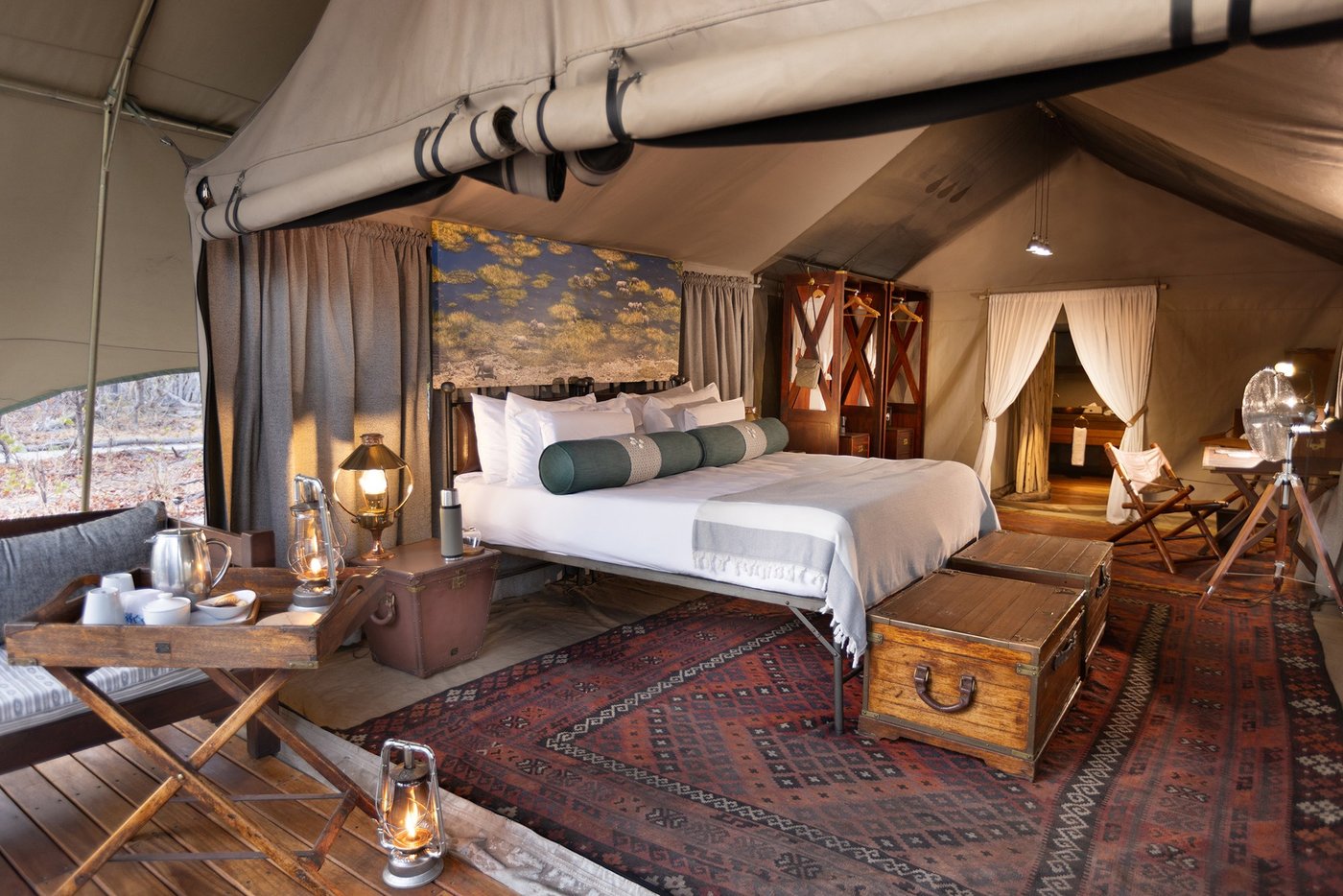 Tented bedroom with leather trunk furniture at Selinda Explorers Camp