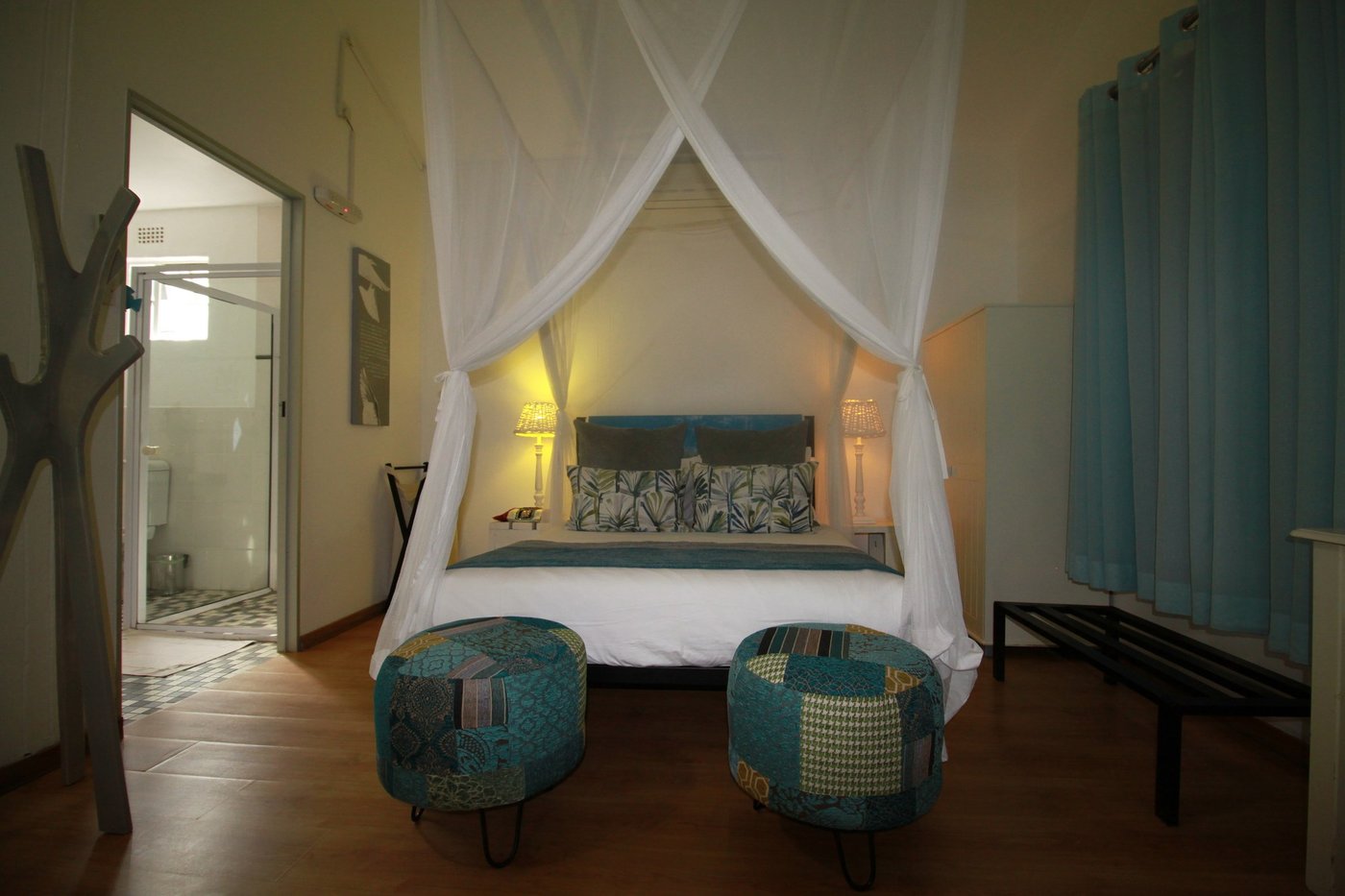 Bedroom with a canopy bed and teal cushions at The Old House