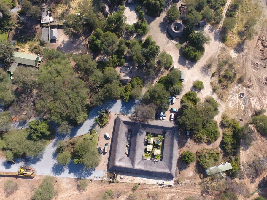 Aerial view of the fenced camp compound among trees at Thebe River Safaris, Chobe