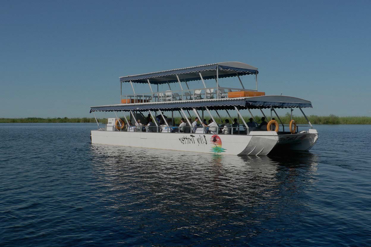 Guests on a double-deck river cruise boat near Water Lily Lodge