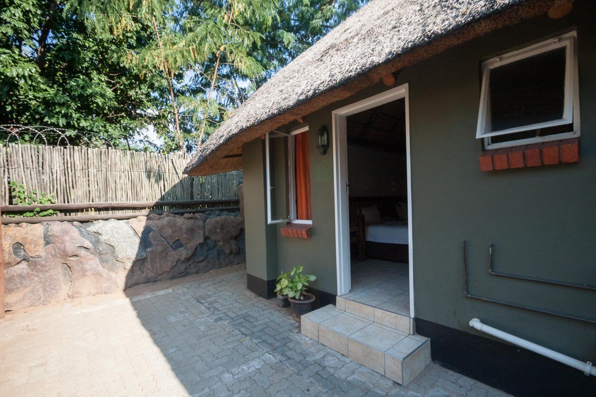 Covered breezeway connecting buildings around a rock garden at Water Lily Lodge