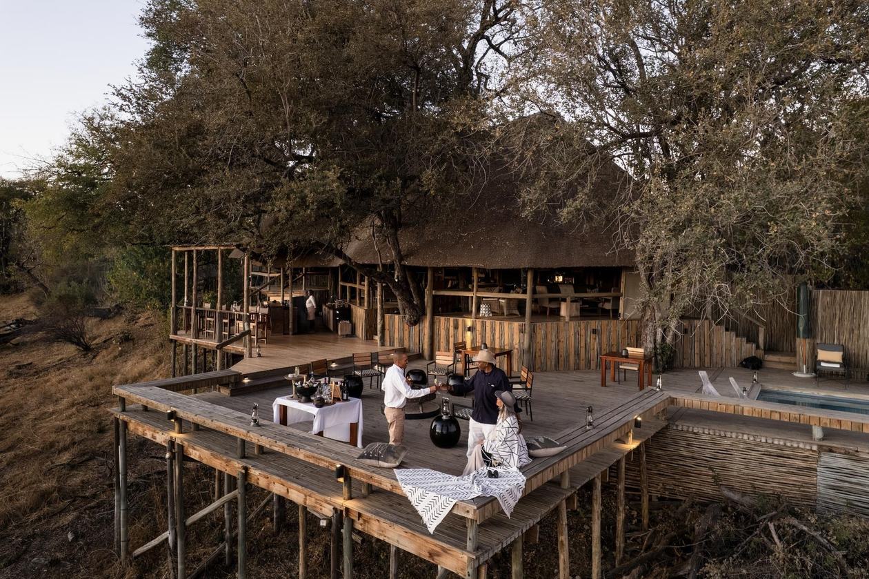 Aerial view of the dining and pool deck among trees at Wilderness Savuti, Chobe