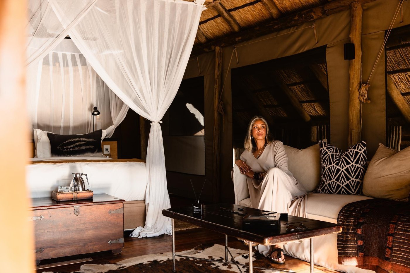 Tented lounge with canopy drapes and soft seating at Wilderness Savuti