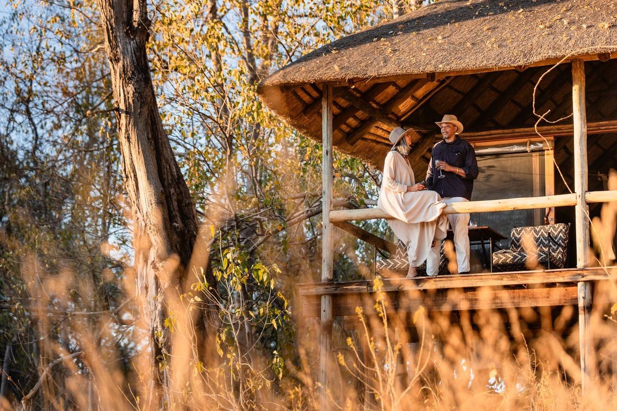 Guests on an elevated viewing deck among the trees at Wilderness Savuti