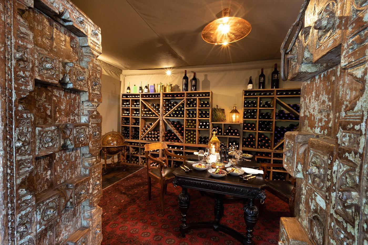 Wine cellar lined with bottles at Zarafa Camp