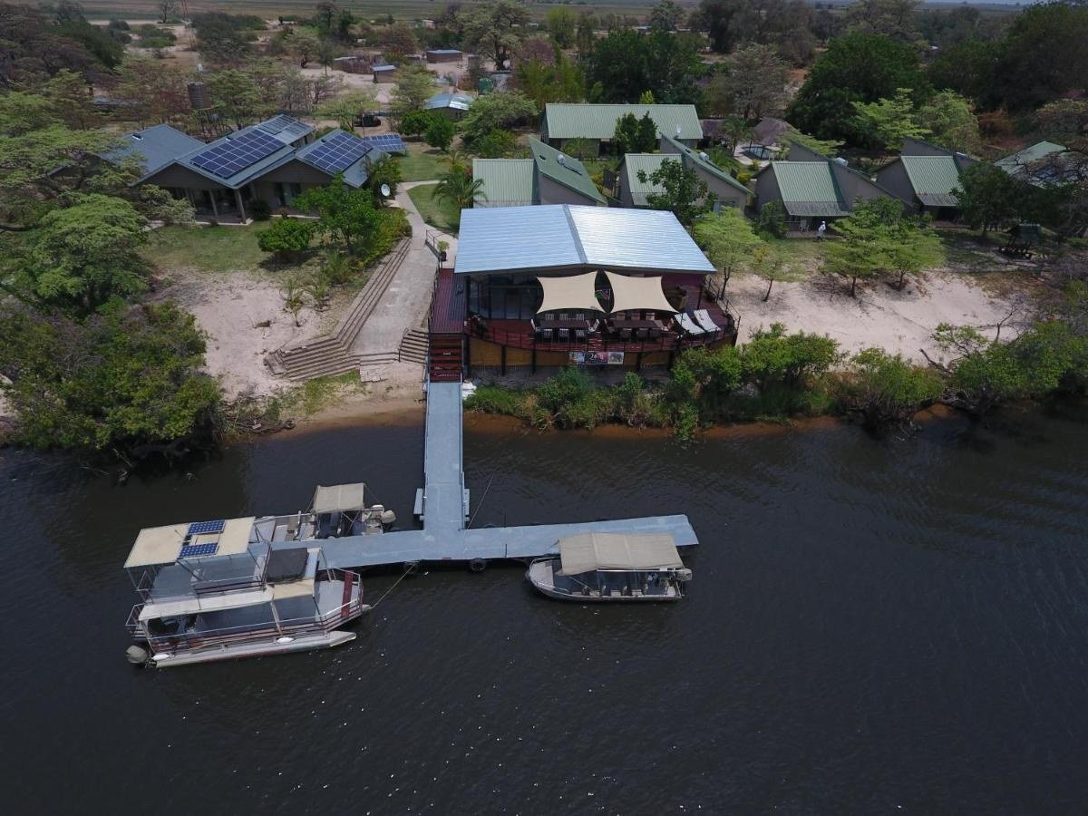 Aerial view of the main building and jetty on the water at Zovu Elephant Lodge